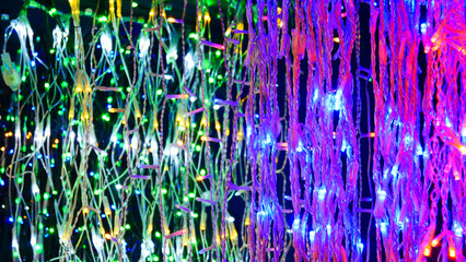 Many wired electric garlands glowing with colorful lights