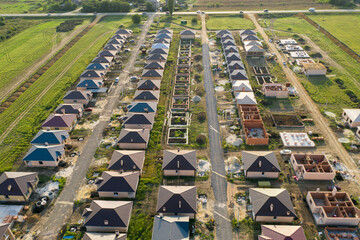 Construction of a suburban neighborhood of cottages. Aerial view.