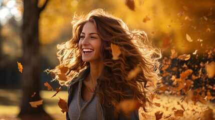 In an autumn park, there is a young woman who is happy and enjoying the leaves.