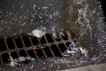 Flow of water during heavy rain and clogging of street sewage. The flow of water during a strong...