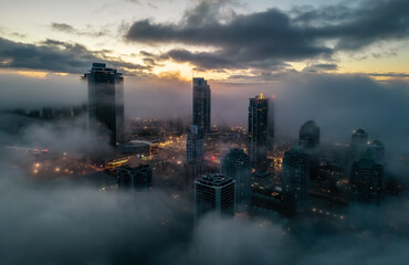 Obraz premium Residential Apartment home Buildings covered in fog at winter sunrise. Modern Cityscape