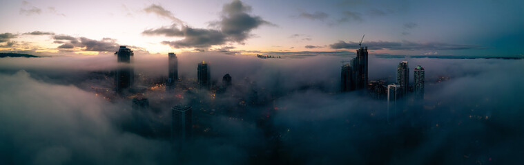 Residential Apartment home Buildings covered in fog at winter sunrise. Modern Cityscape