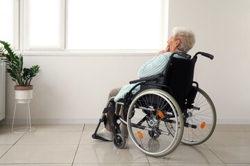 Senior woman in wheelchair at home