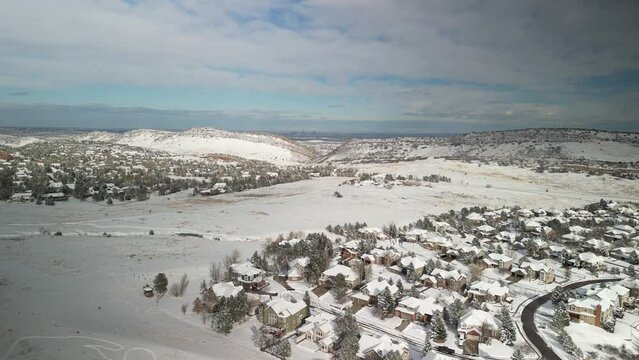 Aerial of snowy neighborhood in south Denver Colorado on snowy winter day in Ken Caryl Ranch