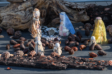 Simple Christmas nativity scene made with shells and pine cones. Random composition encountered on...