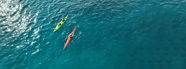 Foto op Plexiglas Aerial drone ultra wide photo of athletes competing with rowing in sport canoe in deep emerald paradise exotic island bay © aerial-drone