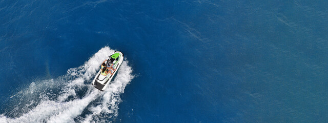 Aerial drone ultra wide panoramic photo with copy space of watercraft with couple cruising in low speed in Caribbean tropical crystal clear waters