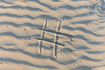 the # sign is drawn on the sand