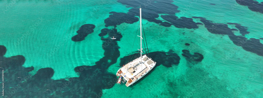 Wall mural aerial drone ultra wide photo of beautiful catamaran sailing yacht anchored in tropical exotic turqu