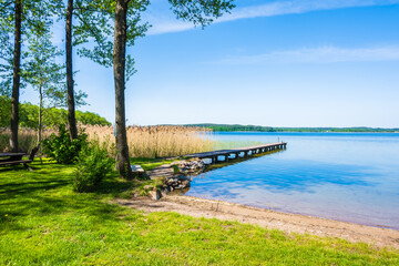 Beach and wooden pier at lake Wigry National Park, Podlasie, Poland