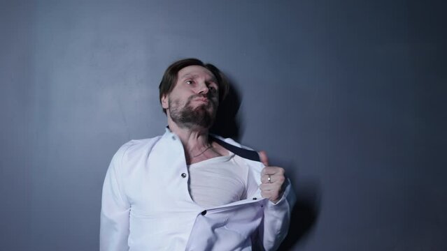 Medical worker feeling sick and catching a breath. Portrait of a man in white uniform infected by a deadly virus in the laboratory. High quality 4k footage