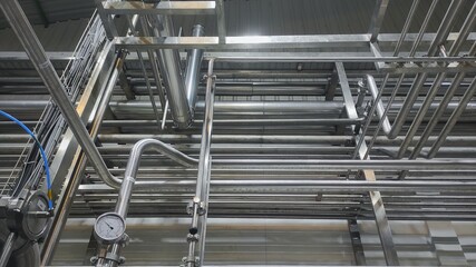 Stainless steel pipe, gauge and valve in production room of factory