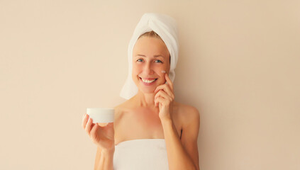 Natural beauty portrait of happy smiling caucasian middle-aged woman touches her clean skin...