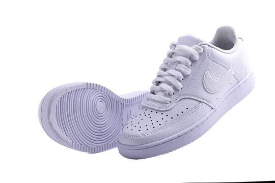White Nike sneakers on white background, sports fashion, walking shoes, sneakers, lifestyle, product photography