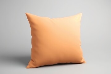 An orange pillow on a gray background, peach fuzz, trendy color of the year 2024.