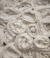 Close up photo of rolled fluffy clean towels at a luxury gym shower or spa pool