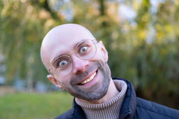 happy young Smiling man joking around, making funny faces, caucasian man 30 years old, close-up...