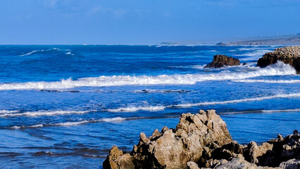 landscape of a beach with rocks and a rough sea marine concept