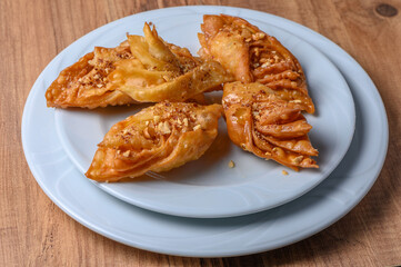 Turkish baklava, sweet dessert with honey on a light plate 14