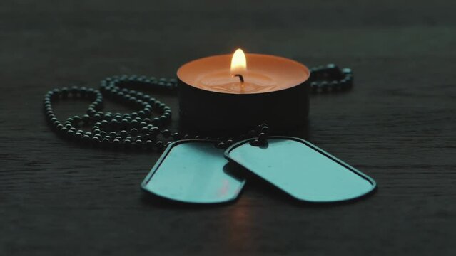 Candle burning, army medallion, mourning and remem