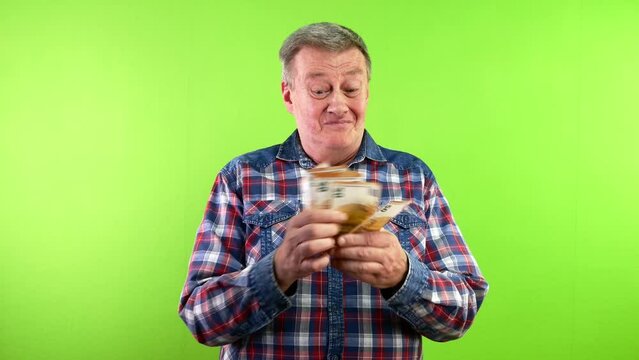 Man counting 50 euro banknotes, smiling pleased.