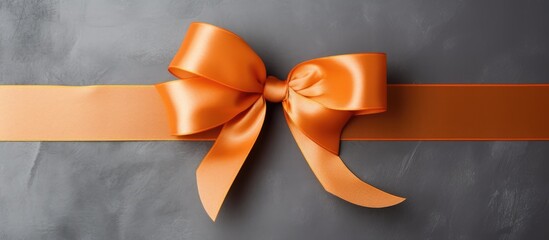 Orange ribbon rope, gray background, top view