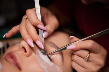 Eyelash Extension Procedure. Woman Eye with Long Eyelashes. Lashes, close up, macro, selective...