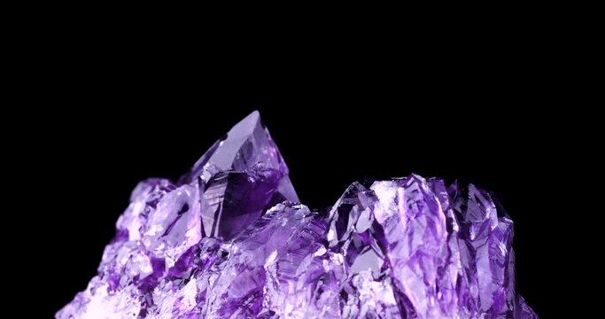 amethyst crystal 360° rotation in 4k isolated on black background. macro detail close-up rough raw unpolished semi-precious gemstone. 