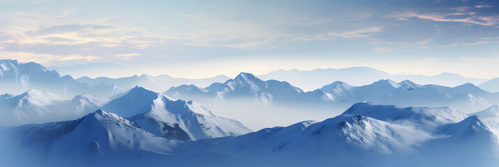 a panoramic view of snowy mountains with snow covered peaks covered with fog and snow in winters