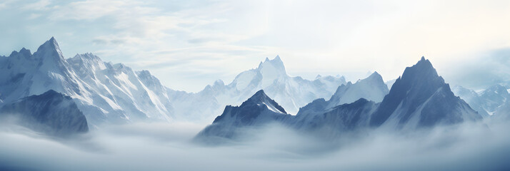 a panoramic view of snowy mountains with snow covered peaks covered with fog and snow in winters