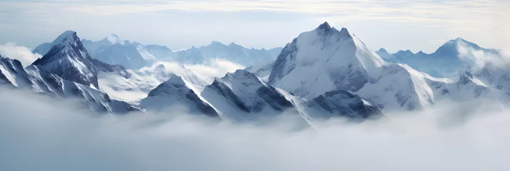 Foto op Plexiglas a panoramic view of snowy mountains with snow covered peaks covered with fog and snow in winters © DailyLifeImages