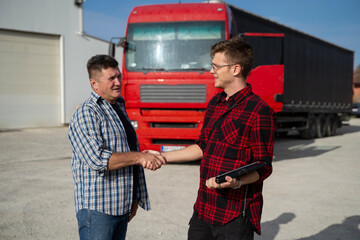 Fleet manger and truck driver shaking hands , having agreement 