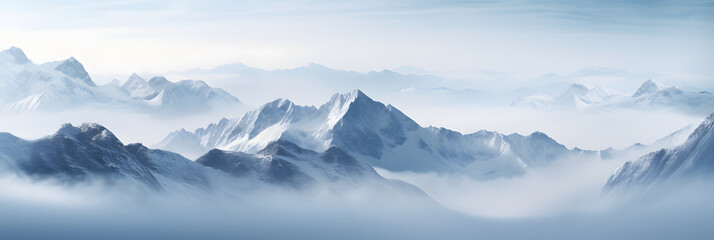 a panoramic view of snowy mountains with snow covered peaks covered with fog and snow in winters - obrazy, fototapety, plakaty