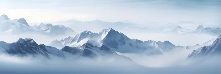 Türaufkleber a panoramic view of snowy mountains with snow covered peaks covered with fog and snow in winters © DailyLifeImages