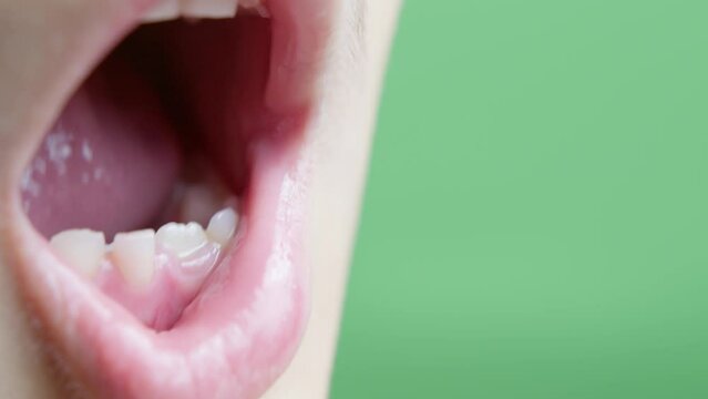 Close up on childs milk teeth. Boy wigling his tooth . High quality 4k footage