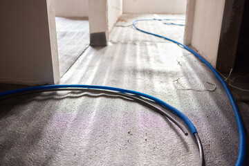Sheet of expanded polystyrene on the concrete floor for house thermal insulation during...