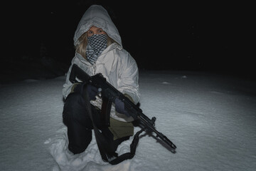 A girl soldier in winter camouflage with an AK 12 assault rifle.