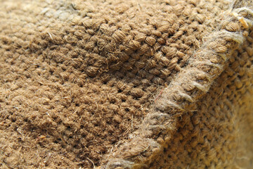 Close up textured abstract background of a brown hessian bag
