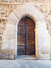 Old wooden horseshoe or moorish arched doorway in historic Spain