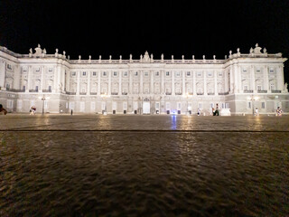 Exterior and courtyard of the historic Royal Palace in Madrid, Spain at night