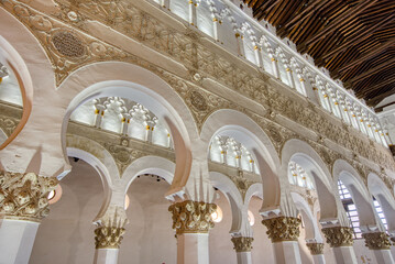 Beautiful old moorish or horseshoe arches in the Synagogue of Santa María la Blanca.  The building is believed to be the oldest surviving synagogue in Europe - obrazy, fototapety, plakaty