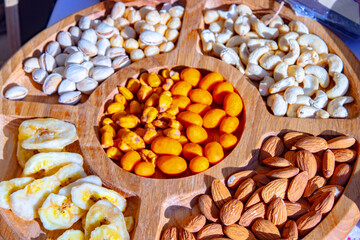 Fresh almonds nut on a wooden table in the summer garden