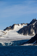 Beautiful glacier flowing into Smeerenburg Fjord, climate change showing in the melting ice, Svalbard, in the summer arctic
