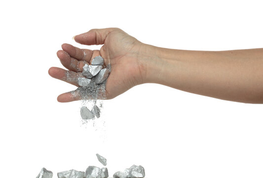 Silver ore nugget fall from industrial Miner hand fingers. Many pieces Silver nugget ore stone gravel found in hand of silver Mining industry. White background Isolated throwing freeze stop motion