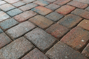 Close up showing driveway area sealant to protect the bricks paving. Sealcoating background for new home construction.	 - obrazy, fototapety, plakaty