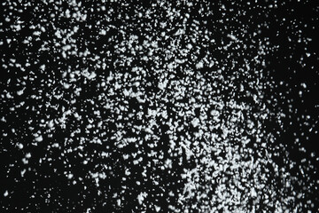 White snow falling down on black background