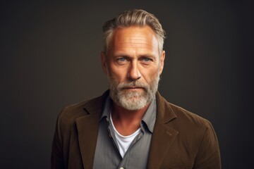 Portrait of a handsome mature man with grey hair and beard.