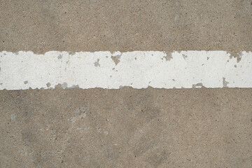 White lines, peeling paint on the cement floor of the old stadium