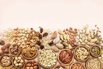 Colorful mix of various nuts: peanut and cashew, hazelnut and almond, pine nuts and walnut; healthy...