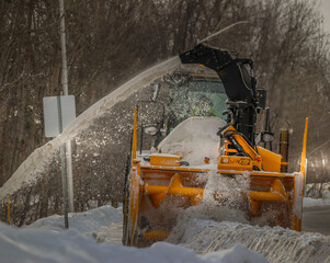 Side walk snow plow machine plowing snow in the winter